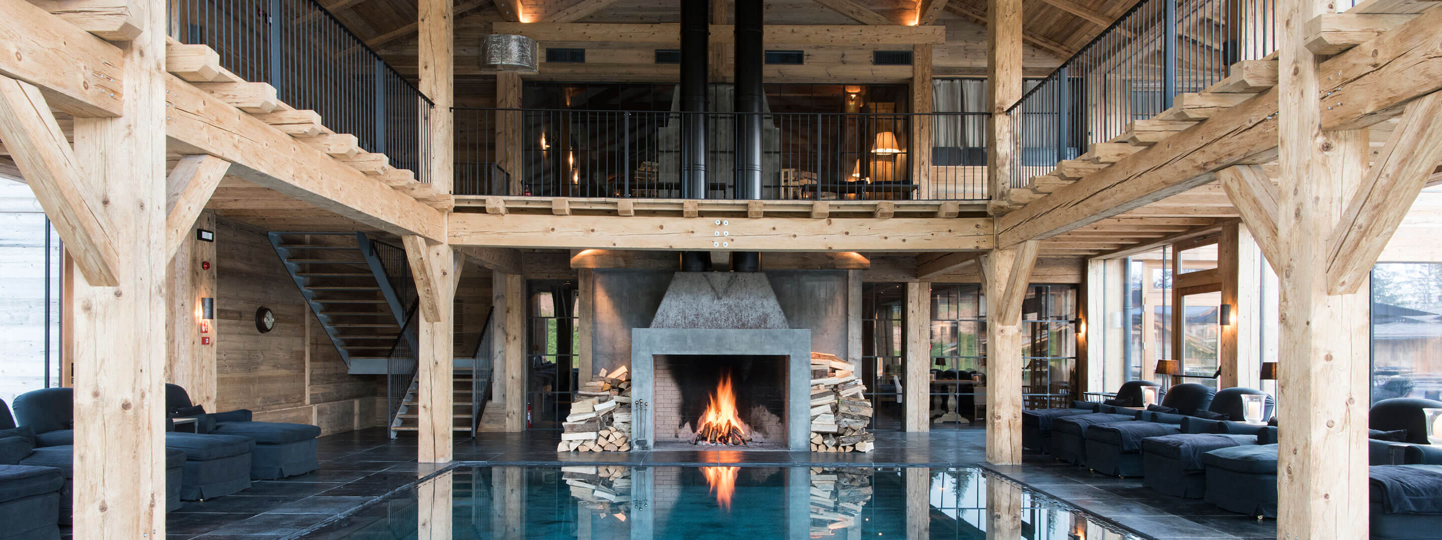 great indoor swimming pool with a cozy open fire